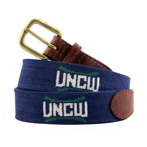 UNC Wilmington Needlepoint Belt Dark Navy coiled, with brown leather trim and a brass buckle