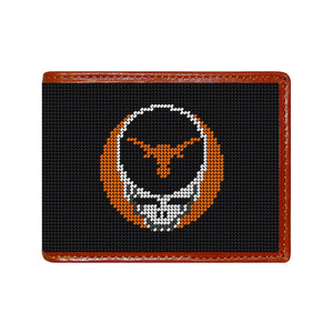 Black stitch-out stamped University of Texas Grateful Dead Steal Your Face needlepoint bi-fold wallet with brown leather trim, shown from primary angle.