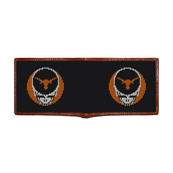 Black stitch-out stamped University of Texas Grateful Dead Steal Your Face needlepoint bi-fold wallet with brown leather trim, open view showing both sides of needlepointing.