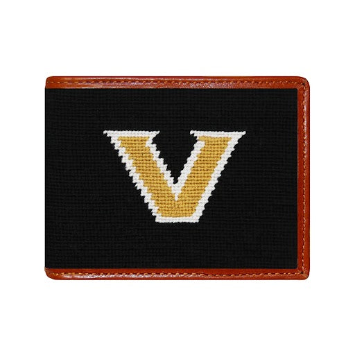 Dark navy Vanderbilt needlepoint bi-fold wallet with brown leather trim, shown from primary angle.