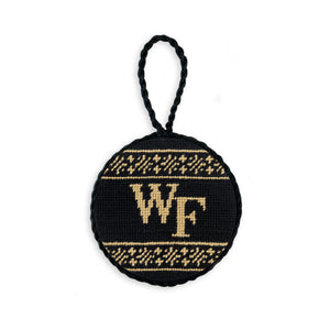 Black needlepoint ornament featuring the gold “WF” Wake Forest logo, finished with a white hanging cord.