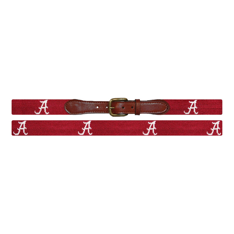 Flat view of Needlepoint Alabama Belt Garnet with brown leather trim and a brass buckle