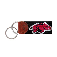 Cardinal red needlepoint key fob featuring the Arkansas Razorback logo, brown leather trim, and a metal key ring.