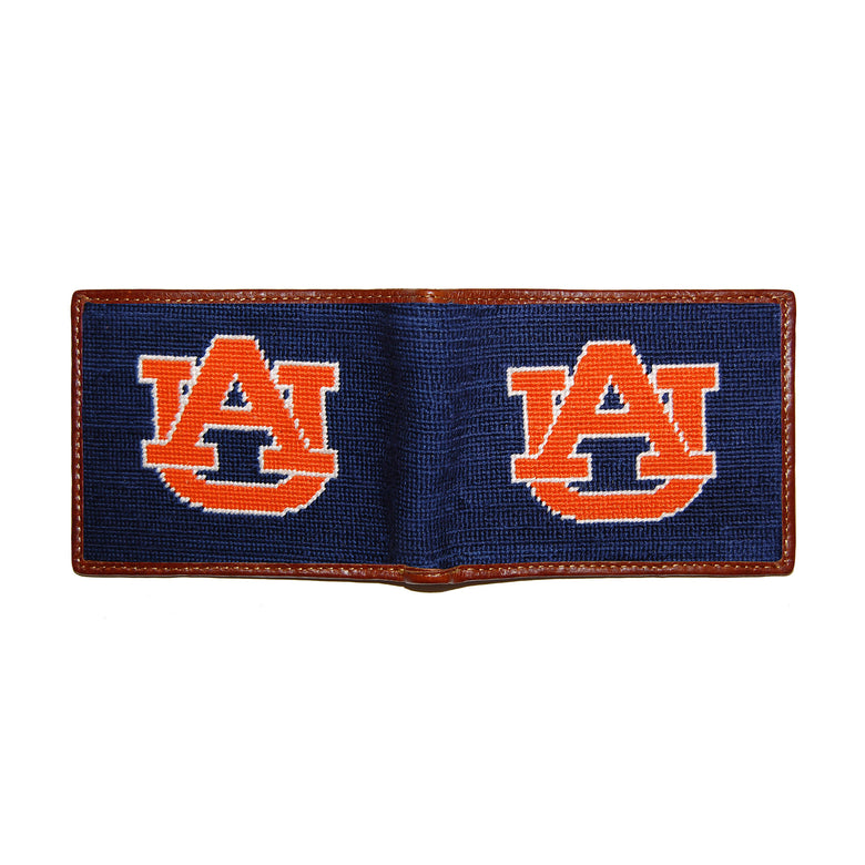 Auburn navy needlepoint bi-fold wallet open to show both sides of the orange “AU” logo needlepoint design with brown leather trim.