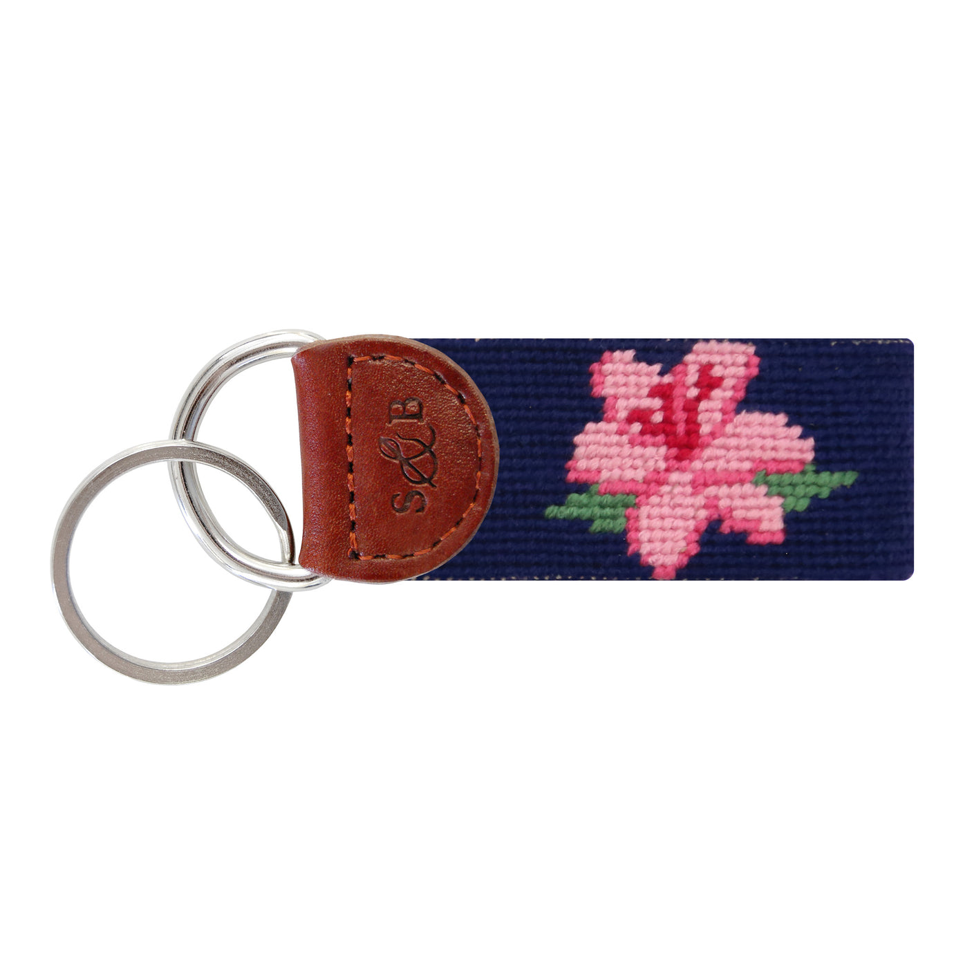 Dark navy needlepoint key fob featuring a pink and green azalea floral pattern, brown leather trim, and a metal key ring.