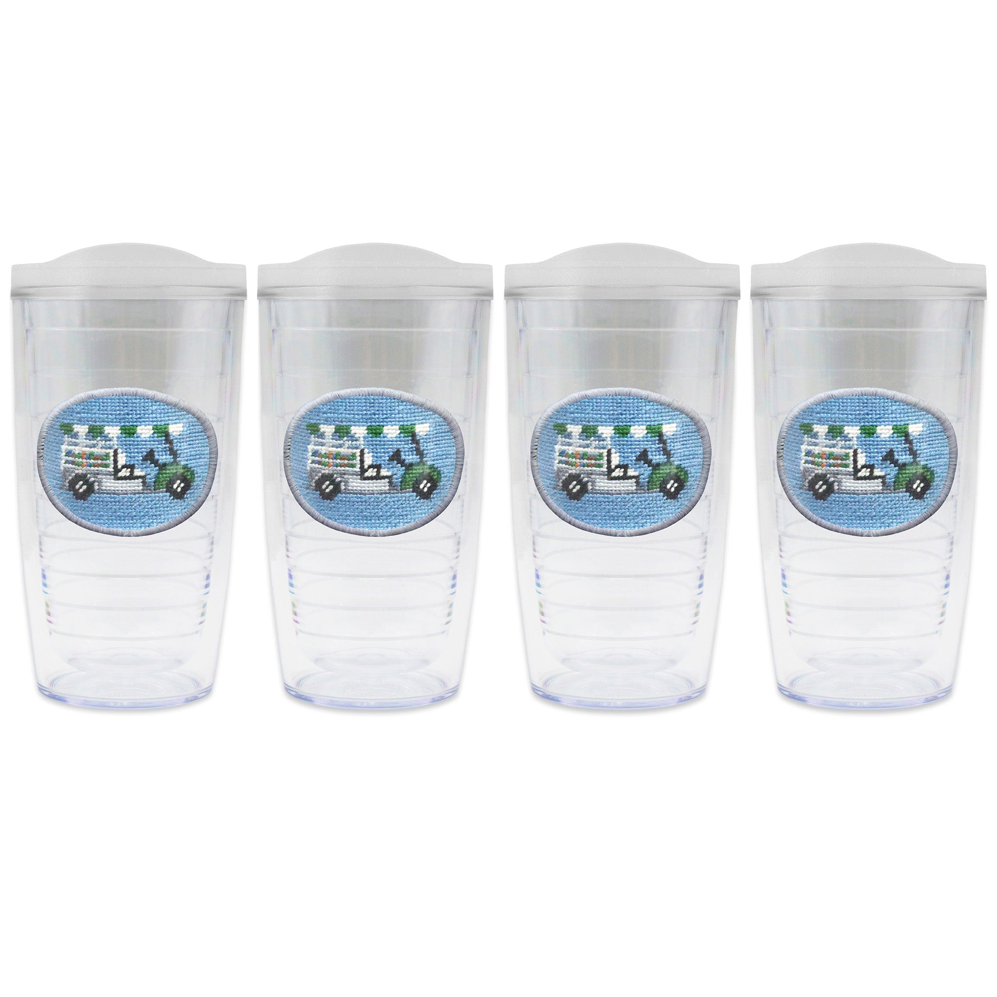 Set of 4 tumblers with lids on each in a line with a needlepoint logo in the center of each tumbler