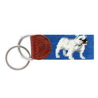 Blueberry needlepoint key fob with a brown and white bulldog face, brown leather trim, and a metal key ring.