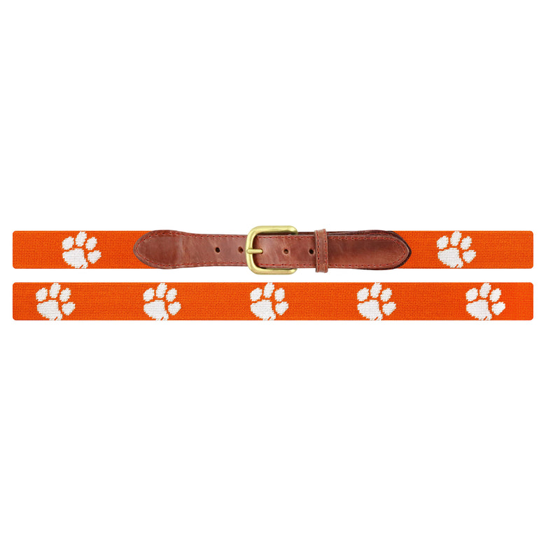 Flat view of Needlepoint Clemson Belt Orange with brown leather trim and a brass buckle
