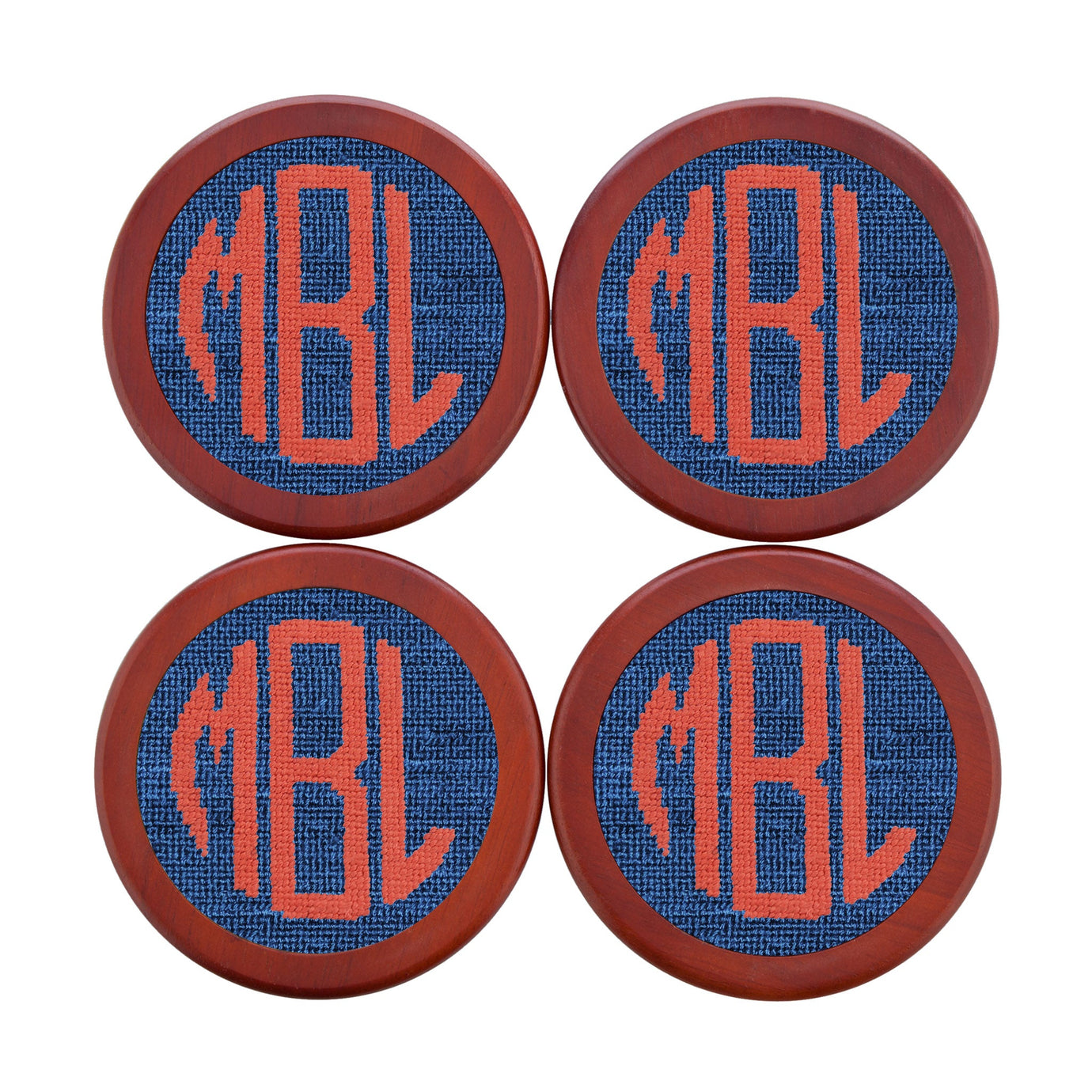 Set of four needlepoint coasters featuring a Circle Sans monogram in blueberry and melon