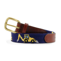 Children’s belt coiled with the stitched construction vehicles on a dark navy needlepoint background, finished with brown leather and a brass buckle.