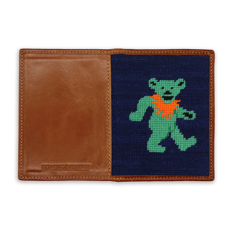 Back view of the dark navy needlepoint passport case with a dancing bear design and a leather trim