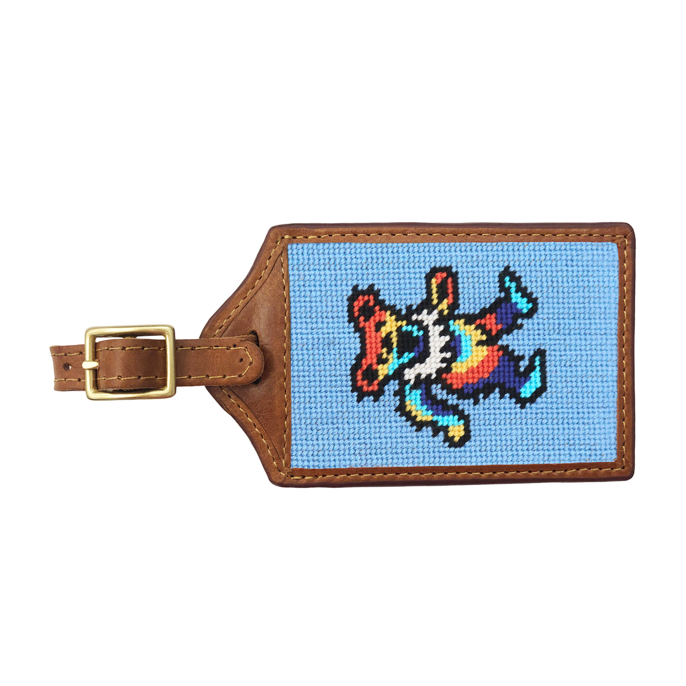 Light blue needlepoint luggage tag with tie-dye dancing bear design, brown leather trim, and an ID window on the back.