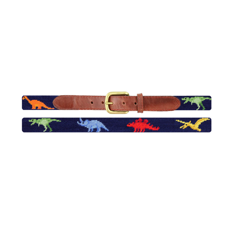 Flat view of Needlepoint Dinosaurs Children's Belt Dark Navy with brown leather trim and a brass buckle