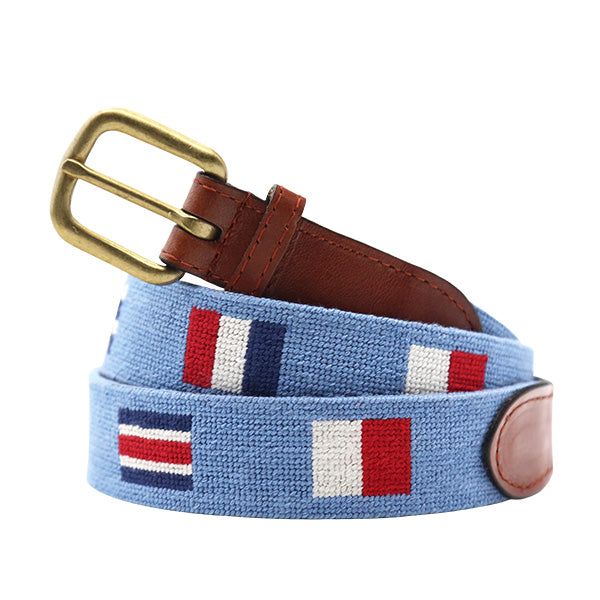 Nautical flag belt with brown leather, brass buckle on a white background