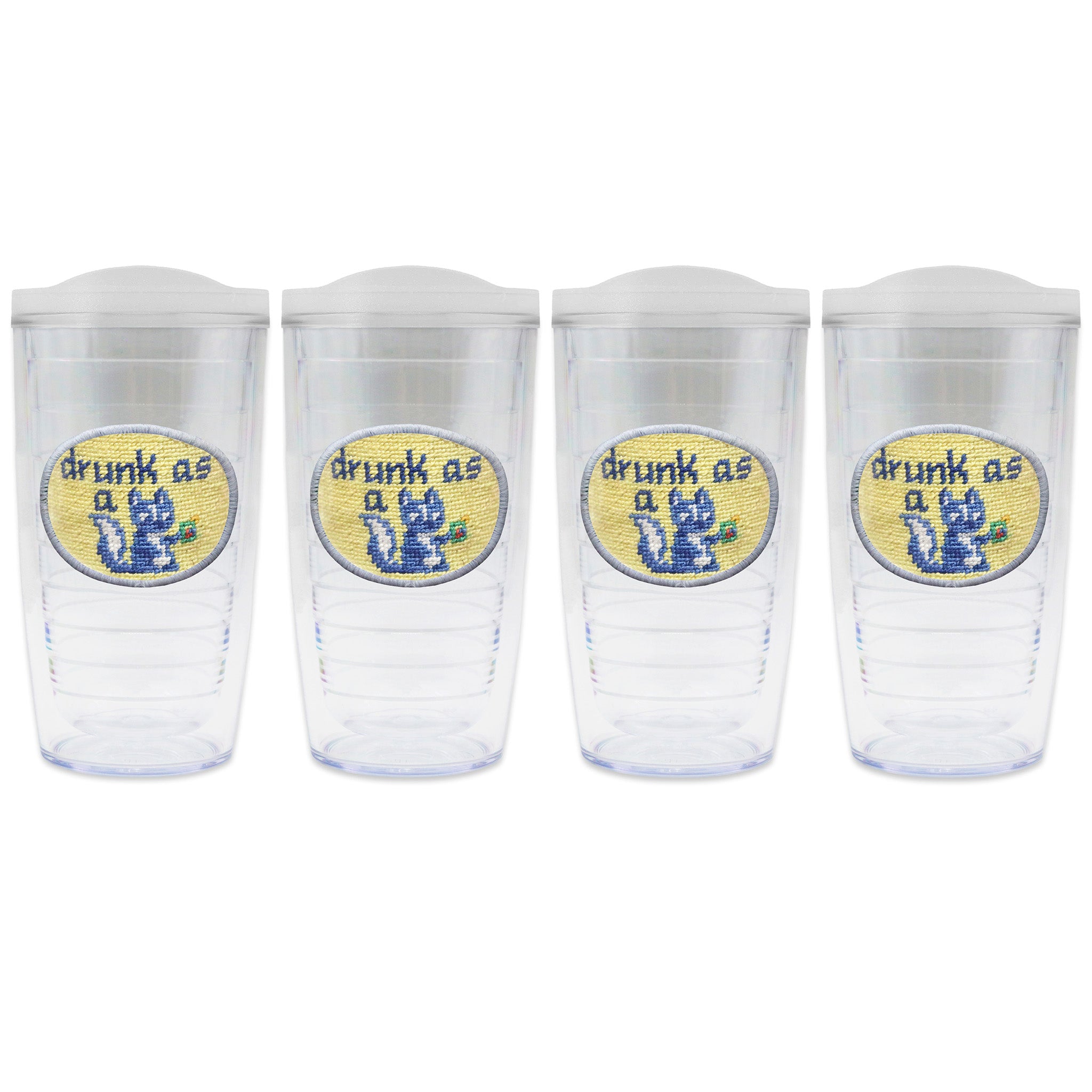 Set of 4 tumblers with lids on each in a line with a needlepoint logo in the center of each tumbler