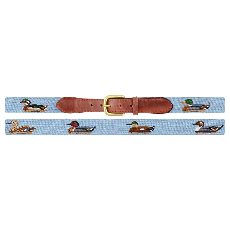 Flat view of Needlepoint Duck Decoys Belt Antique Blue with brown leather trim and a brass buckle
