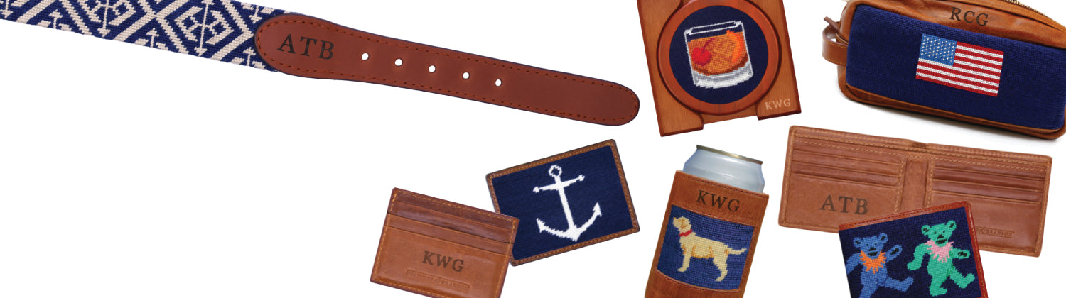 Collection of leather goods including a belt, wallet, and card holders with various designs and branding.