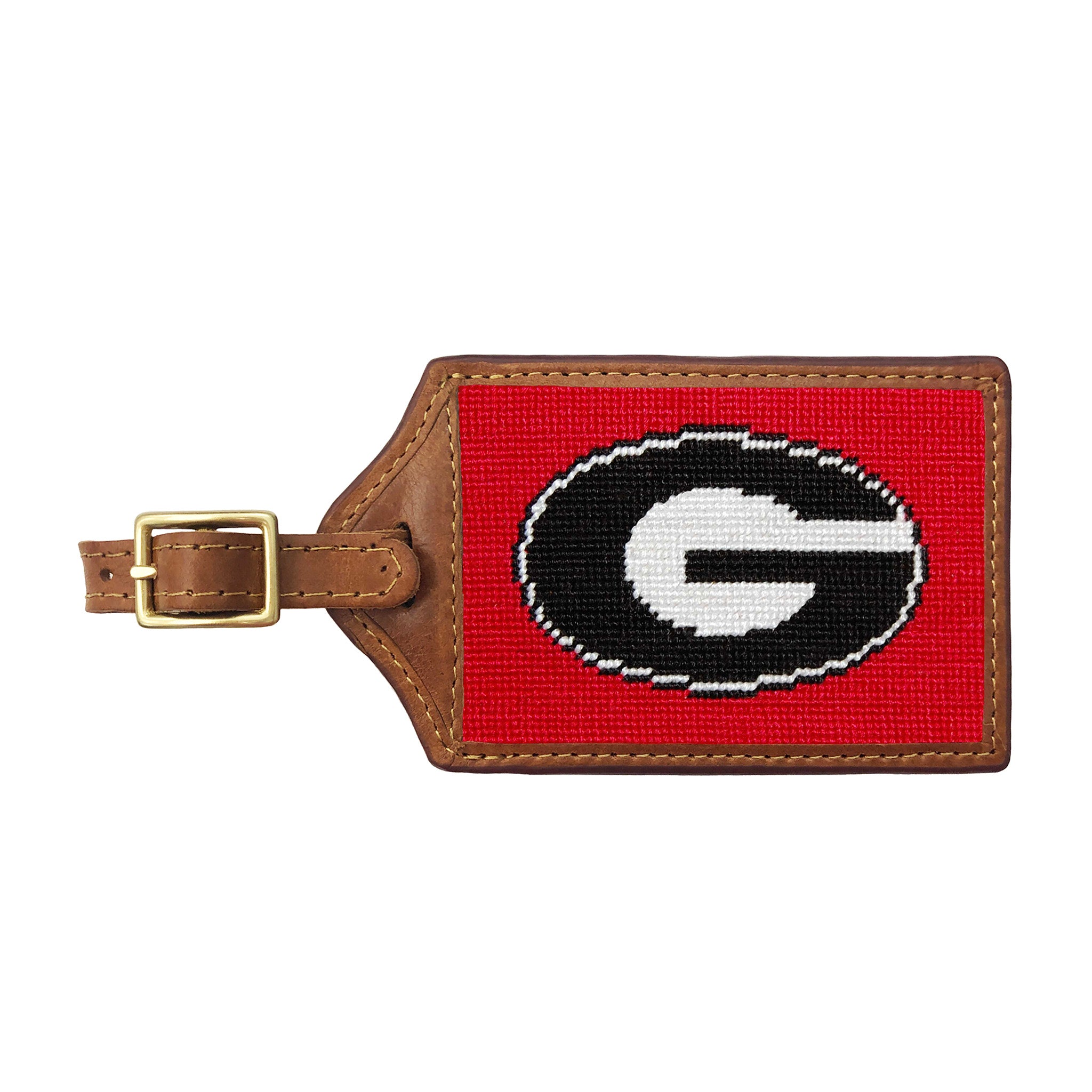 Red needlepoint luggage tag with the black Georgia “G” logo outlined in white, brown leather trim, and an ID window on the back.