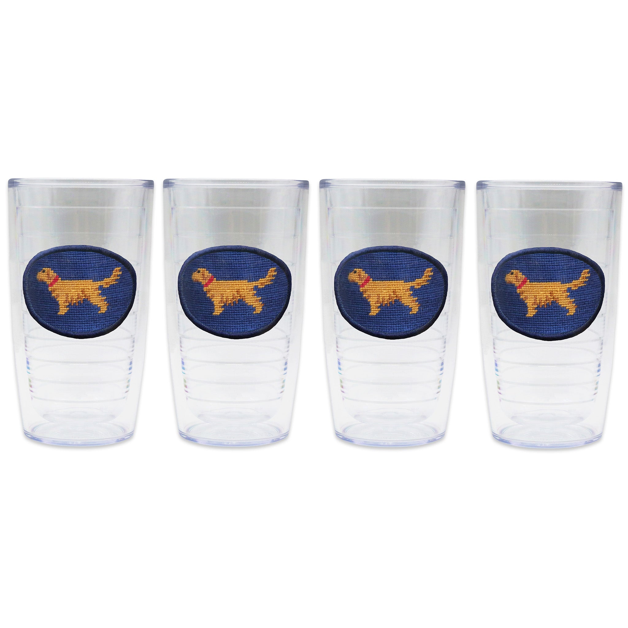 Set of 4 tumblers in a line with a needlepoint logo in the center of each tumbler
