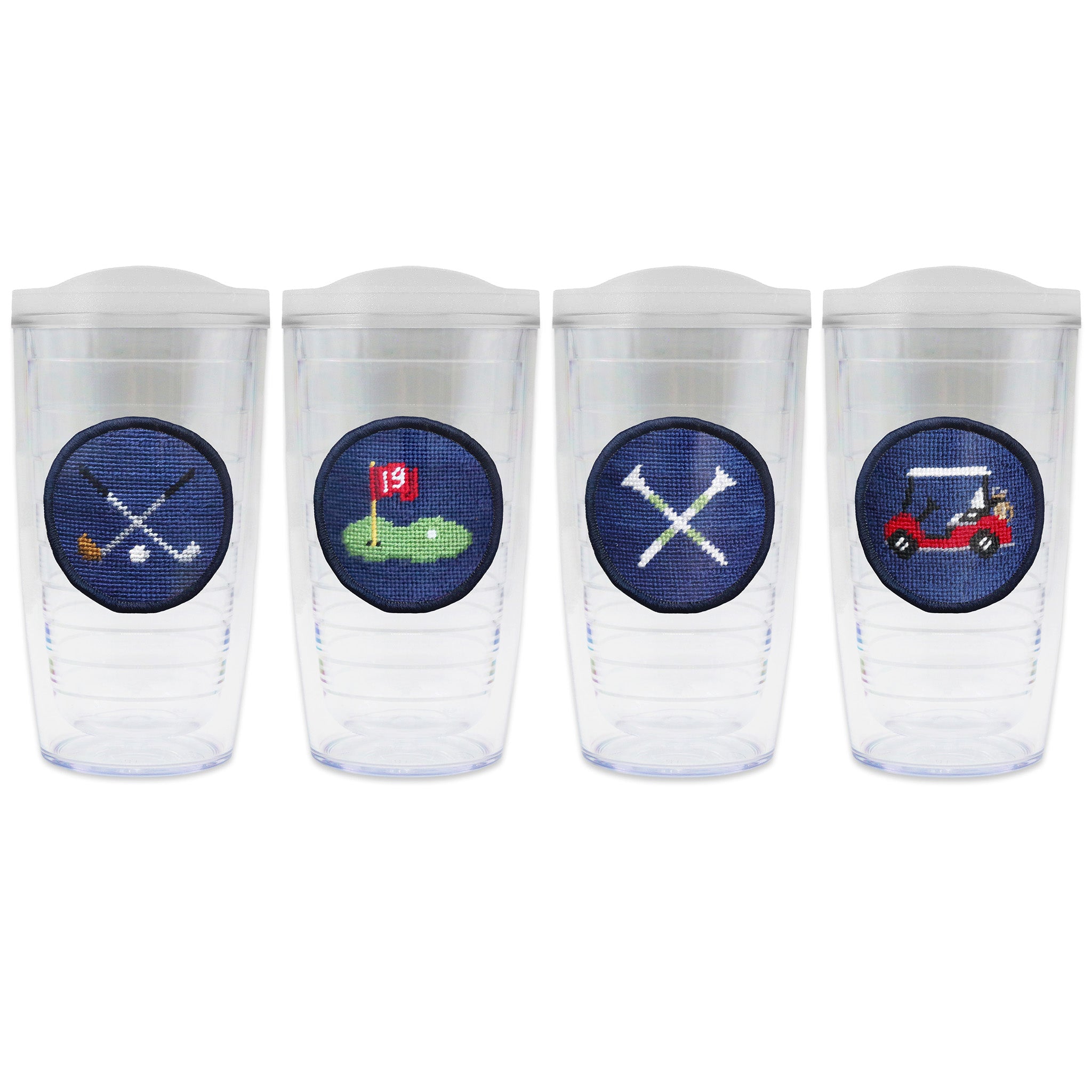 Set of 4 tumblers with lids on each in a line with a needlepoint logo in the center of each tumbler