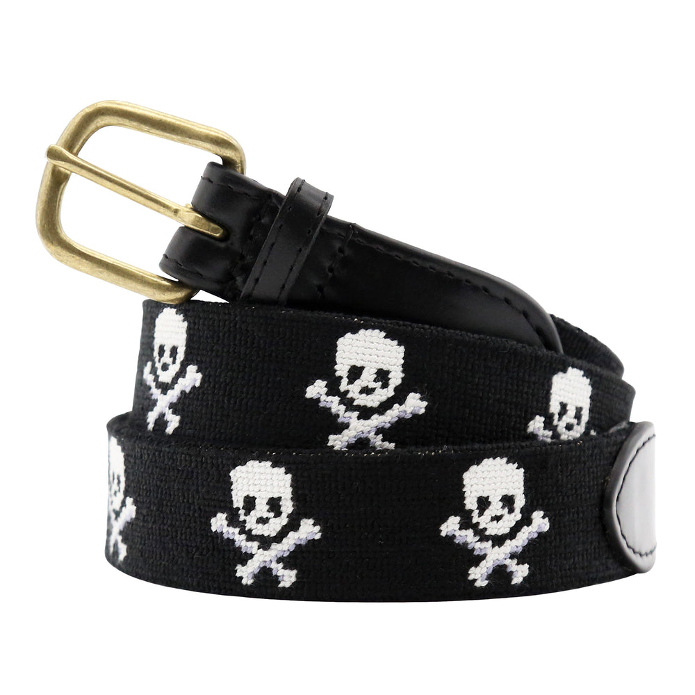 Black belt with skull and crossbones pattern and gold buckle on a white background