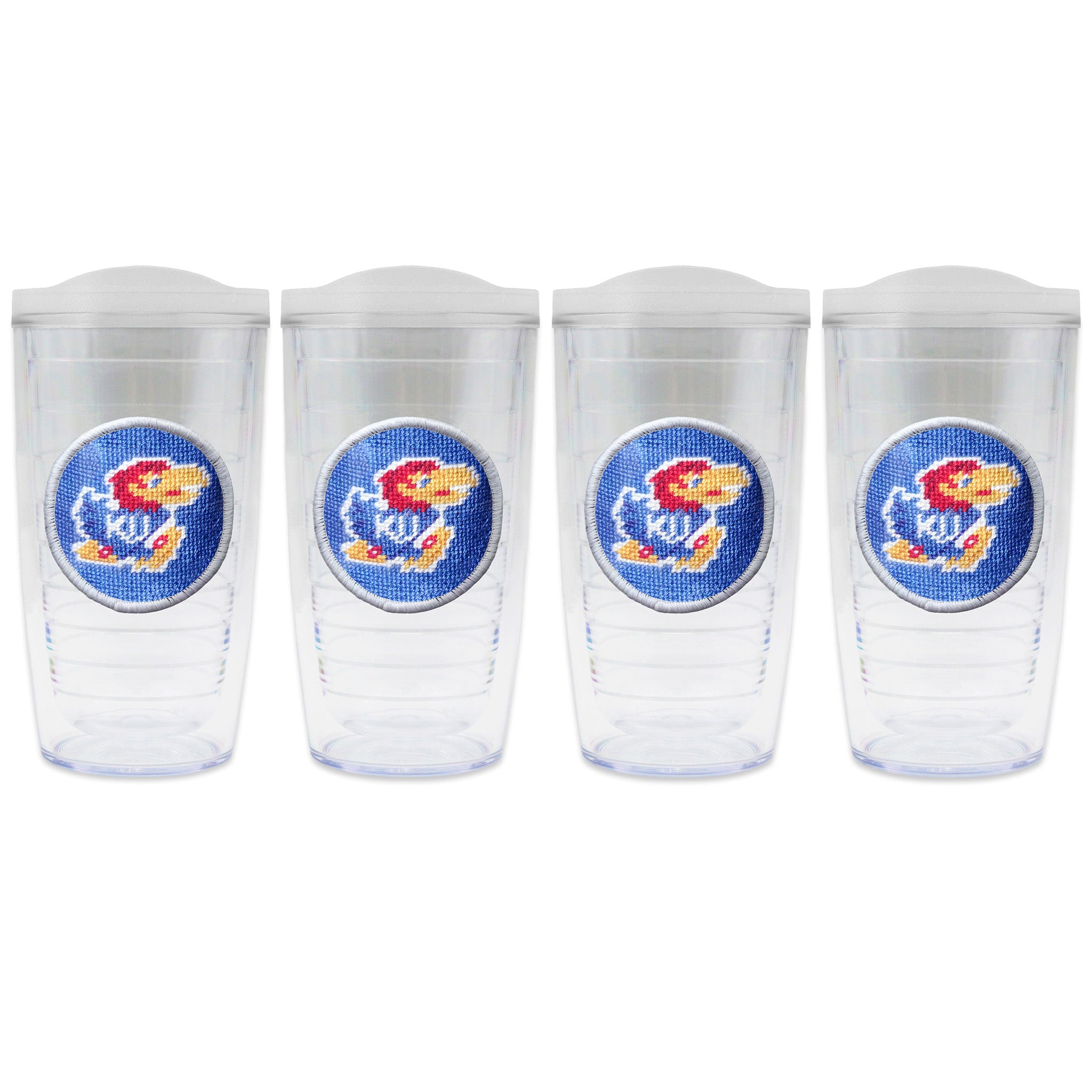 Set of 4 tumblers with lids on each in a line with a needlepoint logo in the center of each tumbler