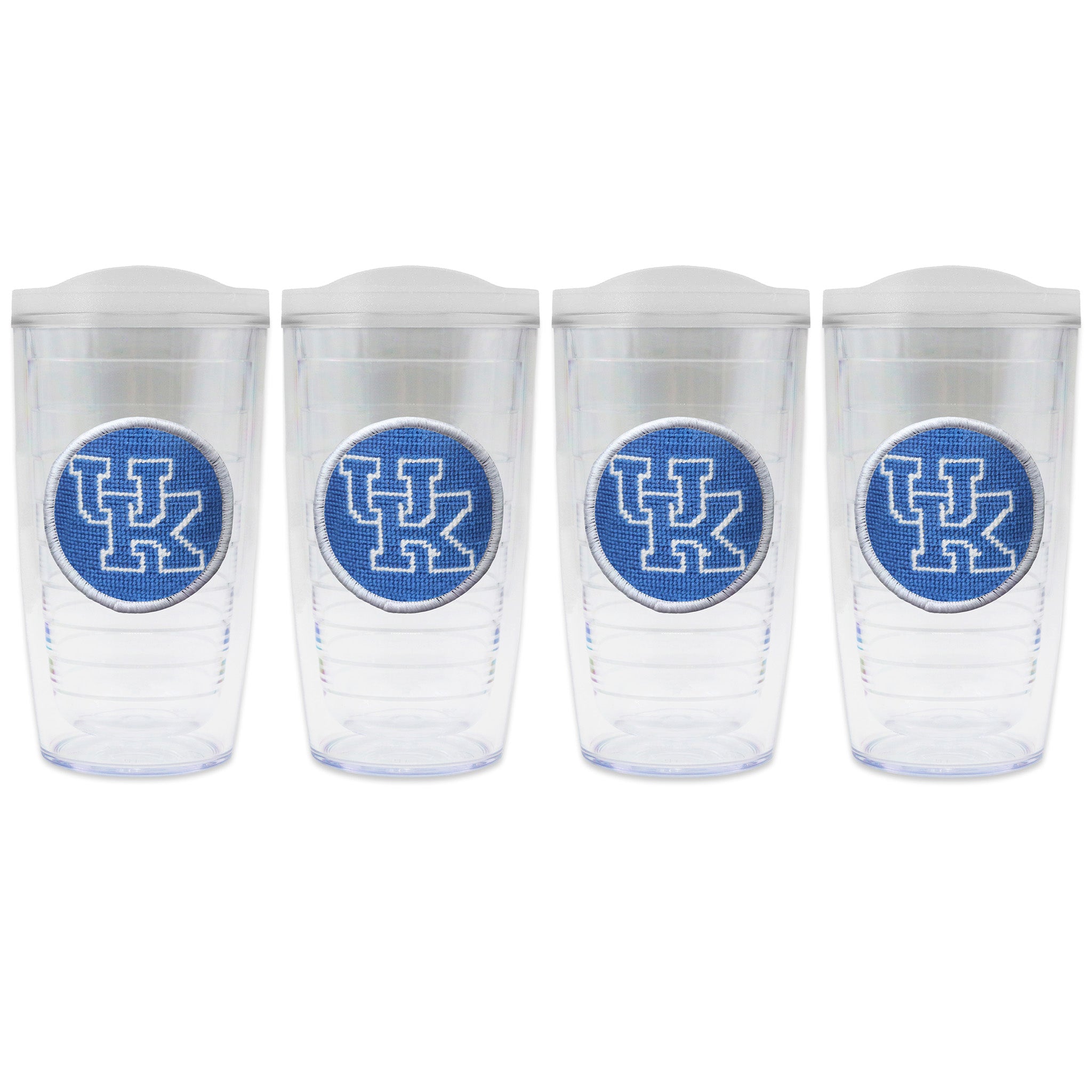 Set of 4 tumblers with lids on each in a line with a needlepoint logo in the center of each tumbler