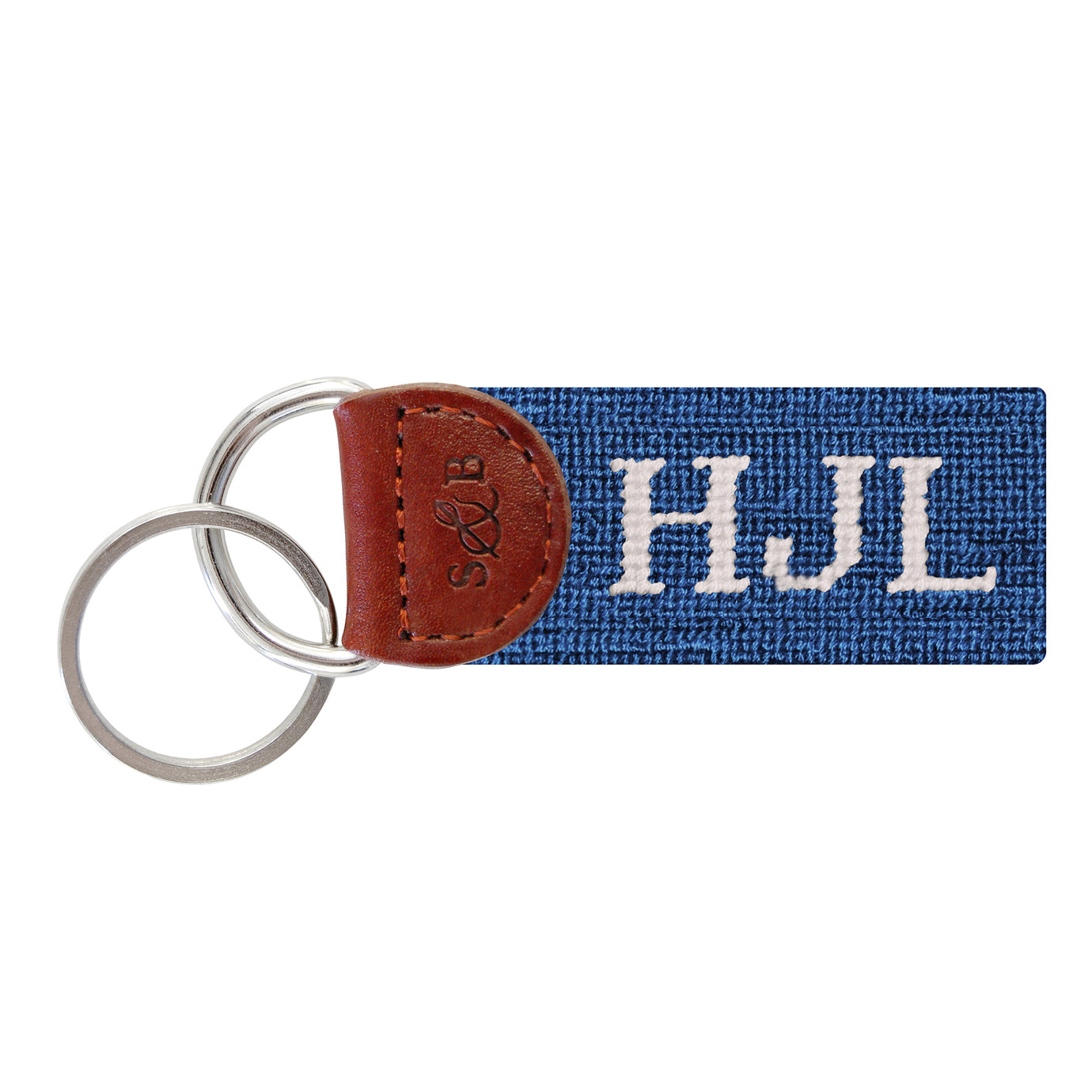 Blue needlepoint key fob with white block-style monogram "10," brown leather trim, and a metal key ring.