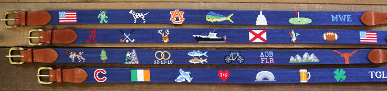 Spread of needlepoint life belts laid out. Featuring four belts.