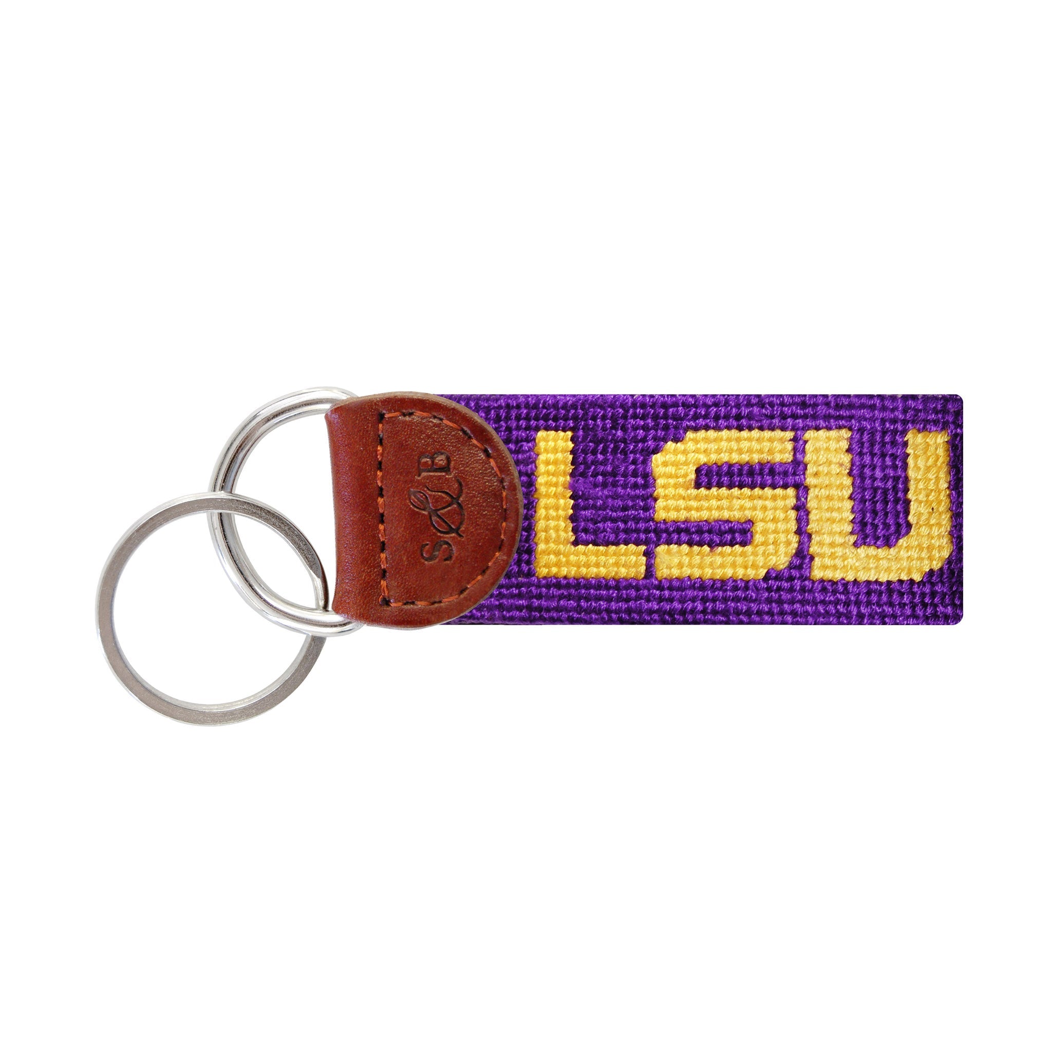 Purple needlepoint key fob with the LSU block letters in gold, brown leather trim, and a metal key ring.