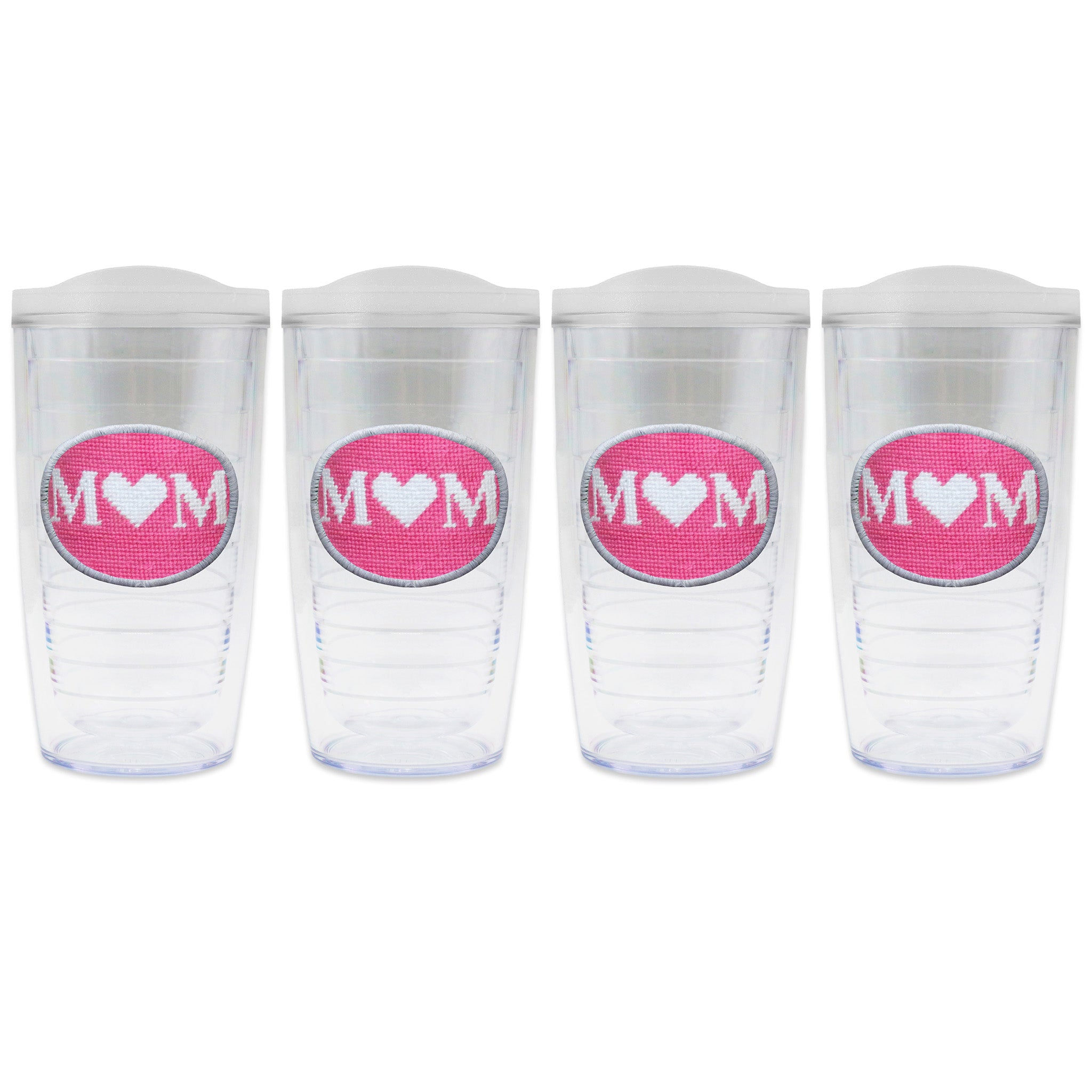 Set of 4 tumblers with lids on each in a line with a needlepoint logo in the center of each tumbler