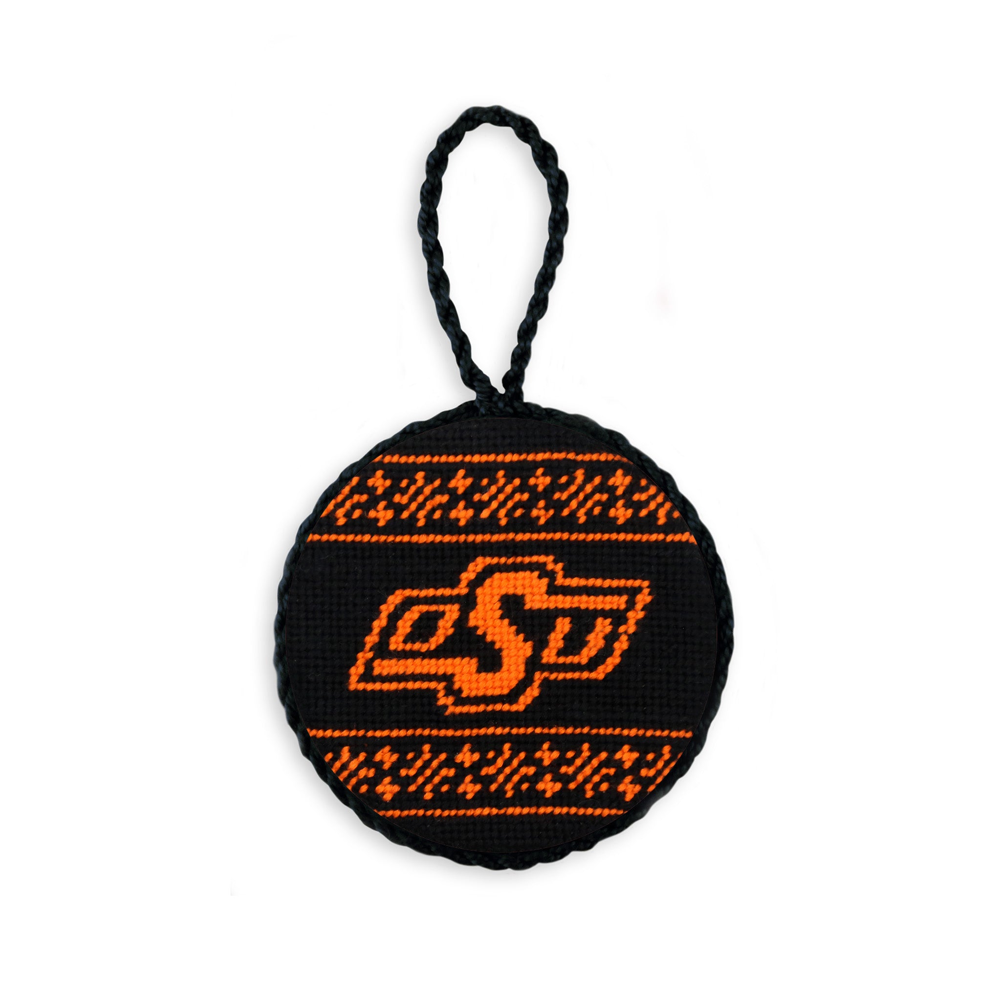 Orange needlepoint ornament with the Oklahoma State “OSU” logo in black and white, finished with a white hanging cord.