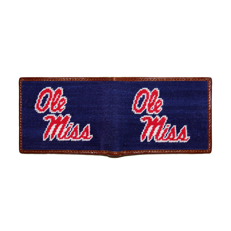 Ole Miss navy needlepoint bi-fold wallet open to show both sides of the red “Ole Miss” script needlepoint design with brown leather trim.