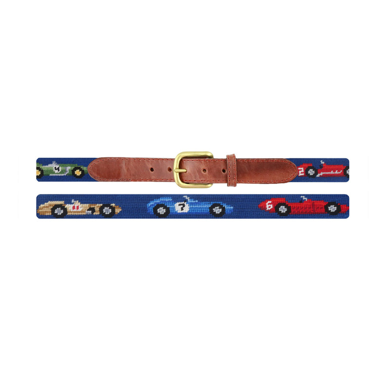 Flat view of Needlepoint Race Cars Children's Belt Classic Navy with brown leather trim and a brass buckle
