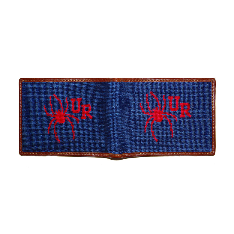Richmond navy needlepoint bi-fold wallet open to show both sides of the yellow “R” logo needlepoint design with brown leather trim.