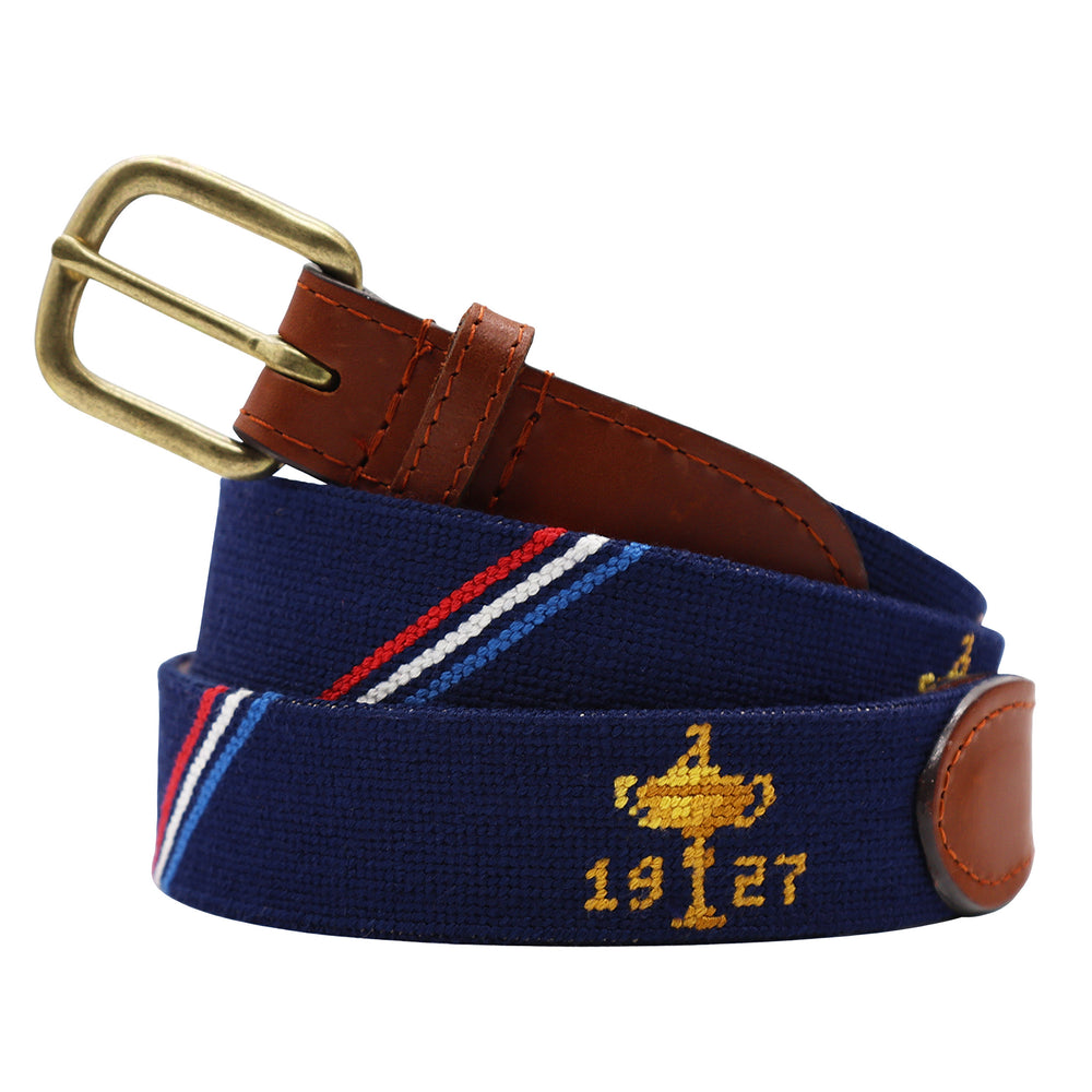 Navy belt with gold trophy design and '1927' text, featuring a gold buckle and brown leather ends on a white background.