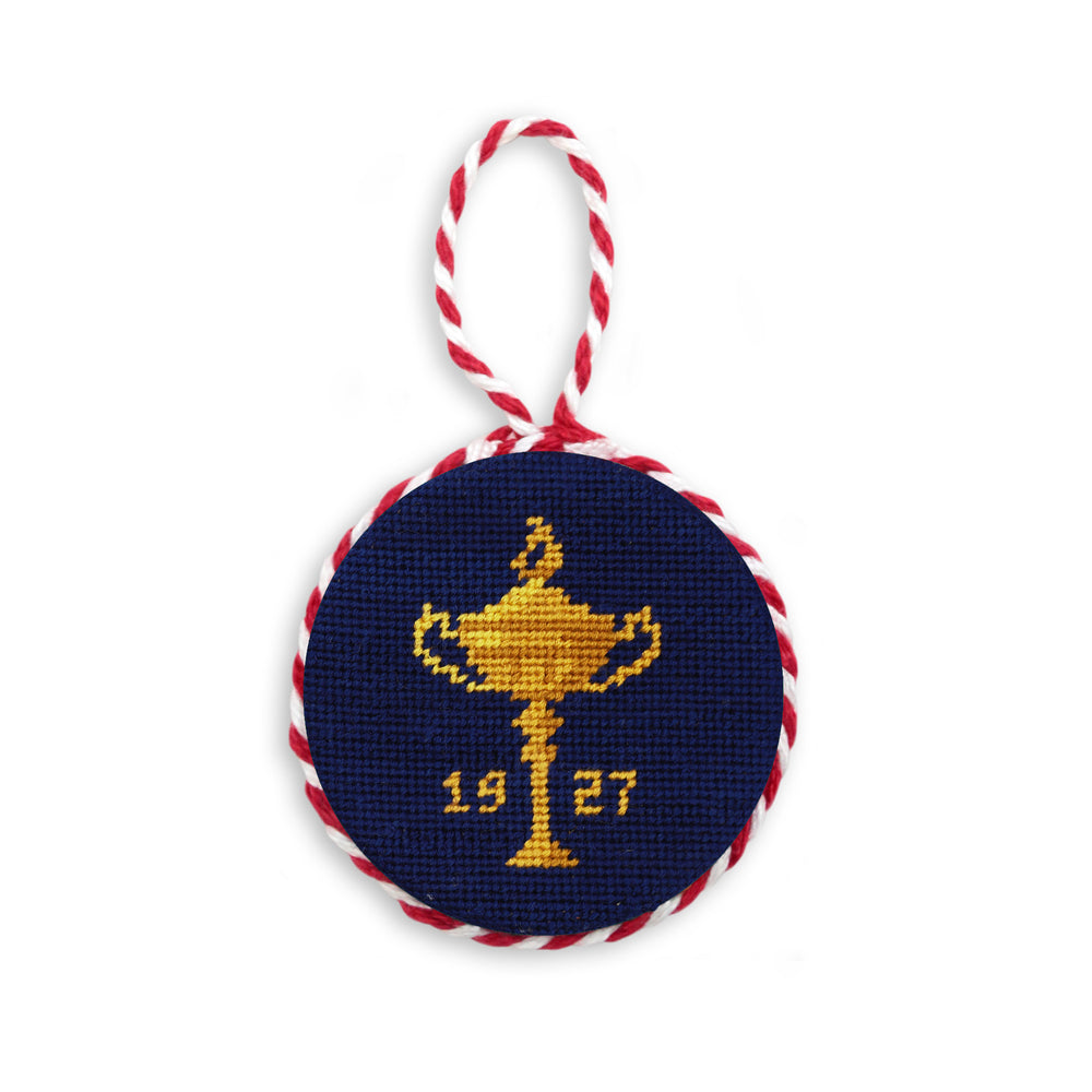 Decorative ornament with a gold trophy design and '1927' text on a navy background, featuring red and white string.