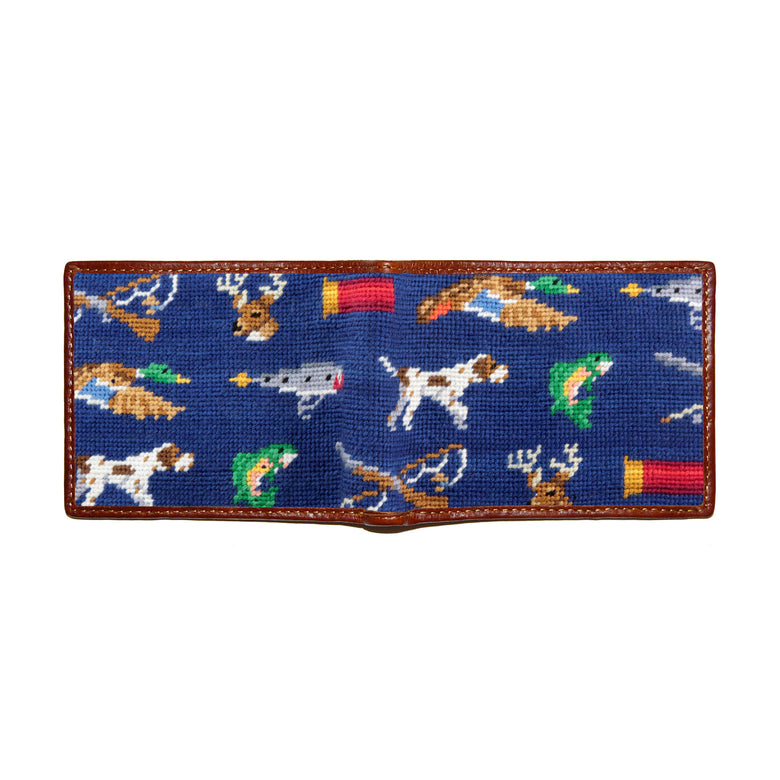 Classic navy needlepoint Southern sportsman-themed bi-fold wallet open to show both sides of the design with brown leather trim.