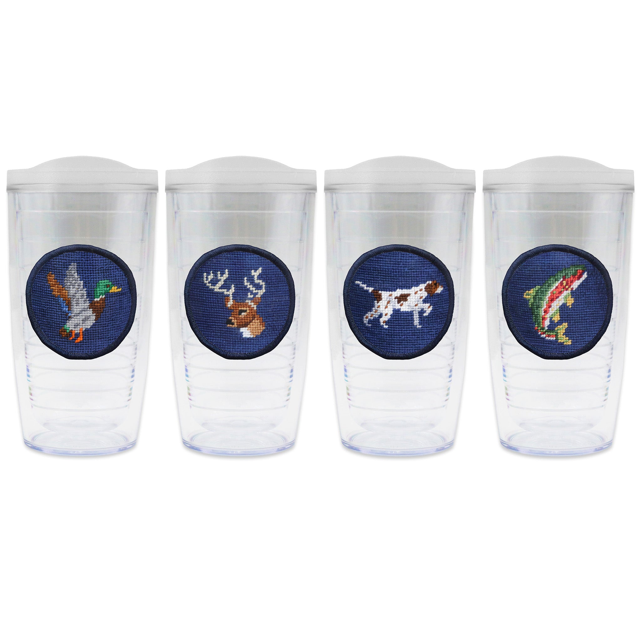 Set of 4 tumblers with lids on each in a line with a needlepoint logo in the center of each tumbler