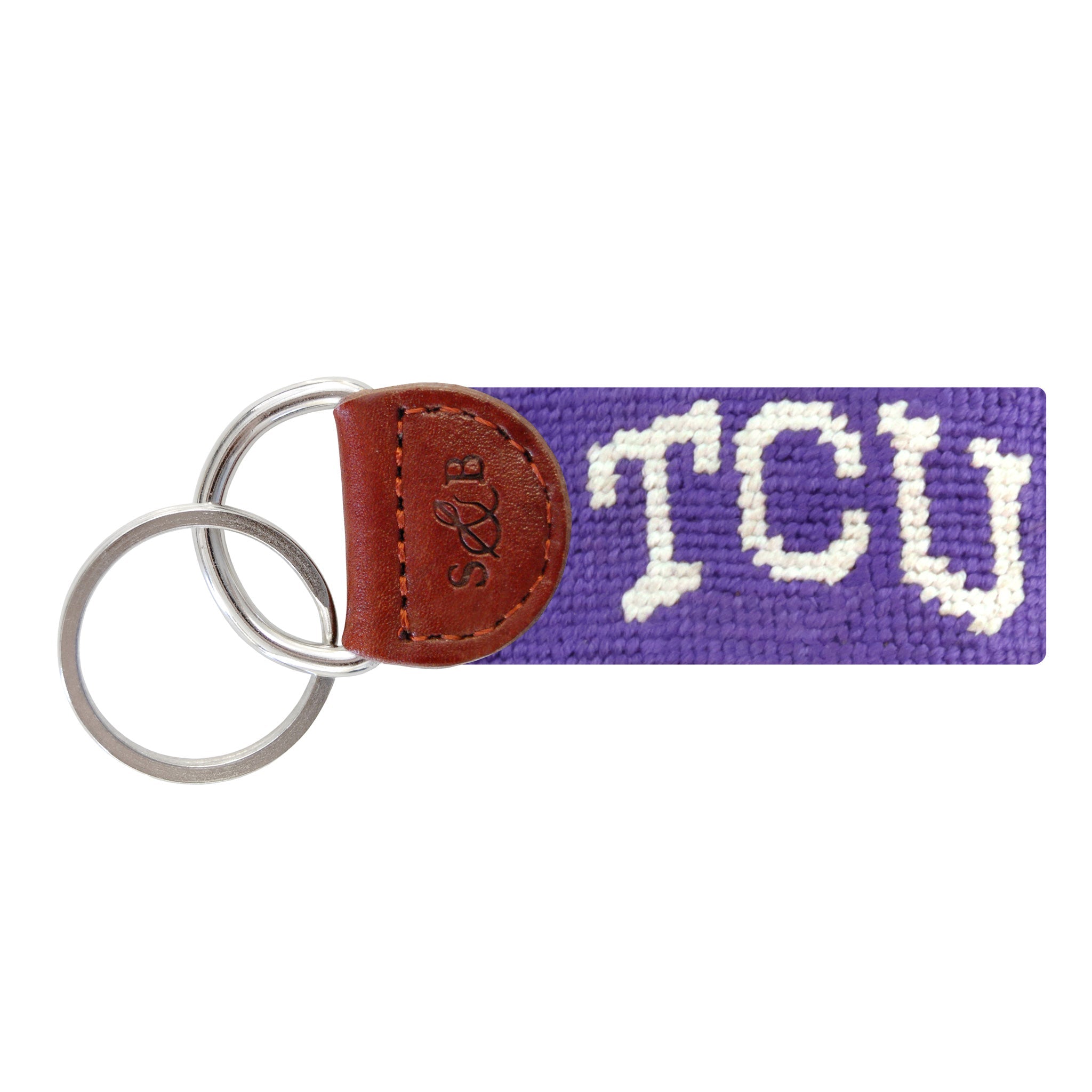 Purple needlepoint key fob featuring the white “TCU” text, brown leather trim, and a metal key ring.