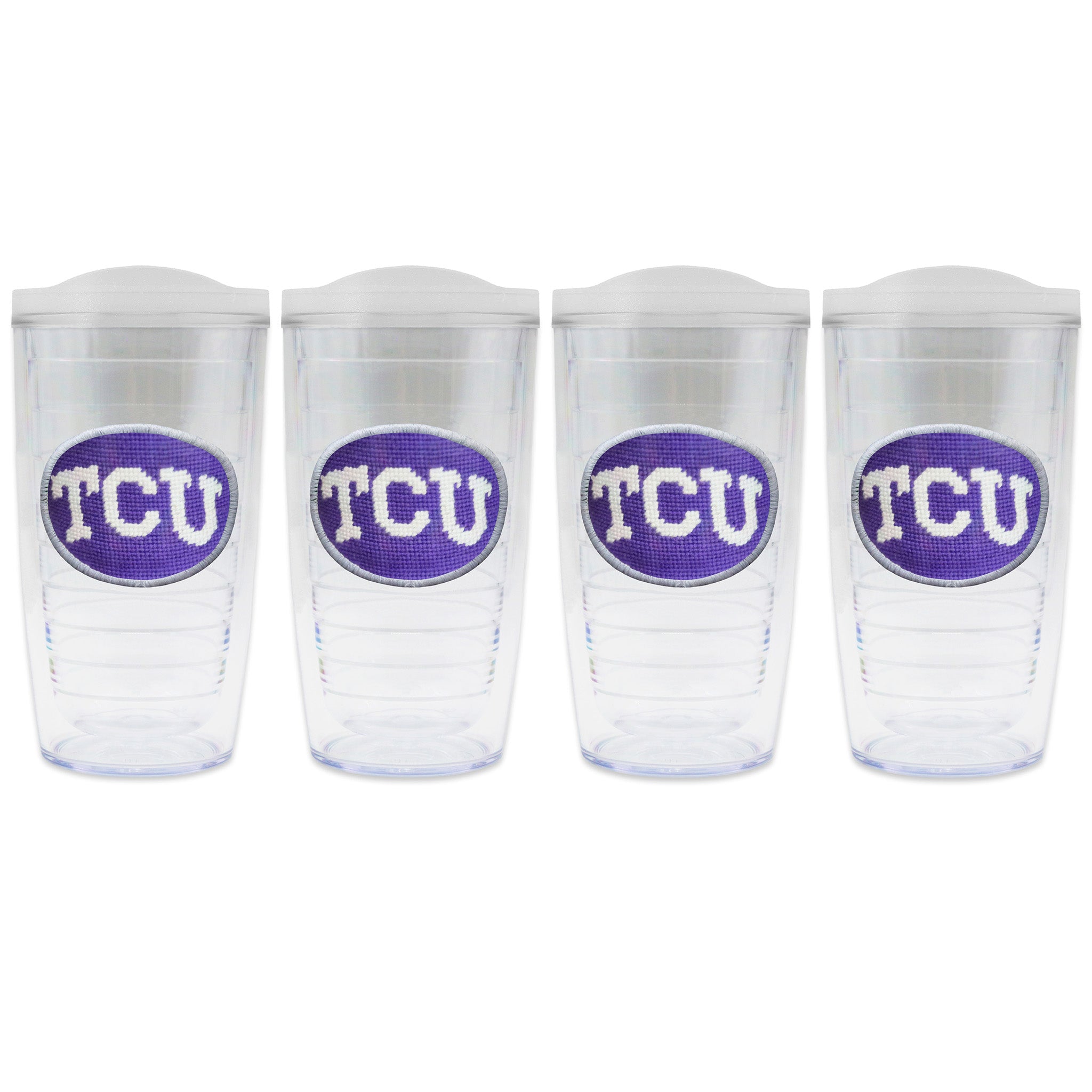 Set of 4 tumblers with lids on each in a line with a needlepoint logo in the center of each tumbler