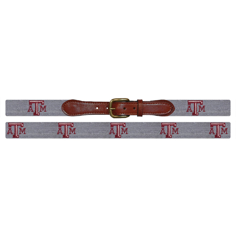Flat view of Needlepoint Texas A&M Belt Grey with brown leather trim and a brass buckle