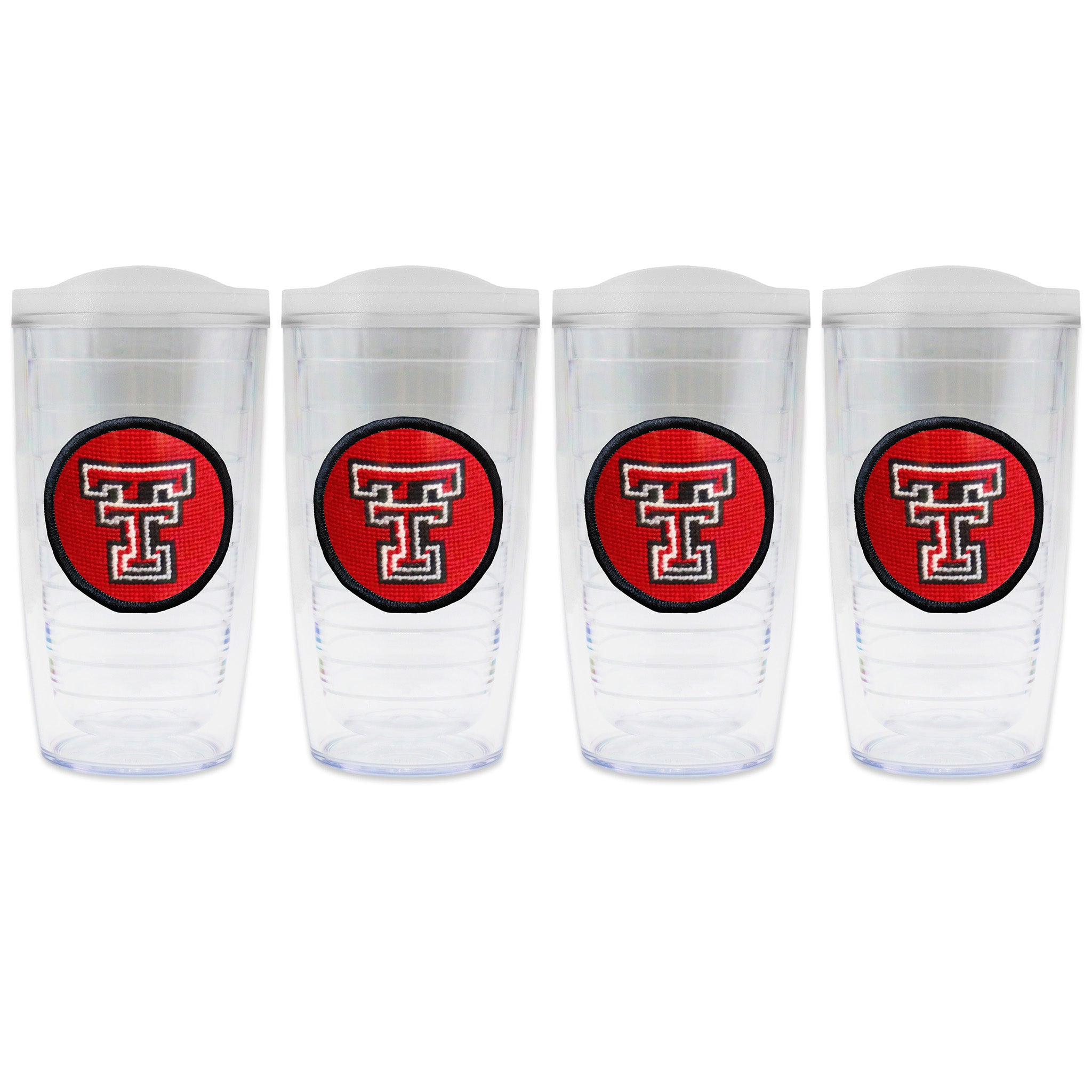 Set of 4 tumblers with lids on each in a line with a needlepoint logo in the center of each tumbler