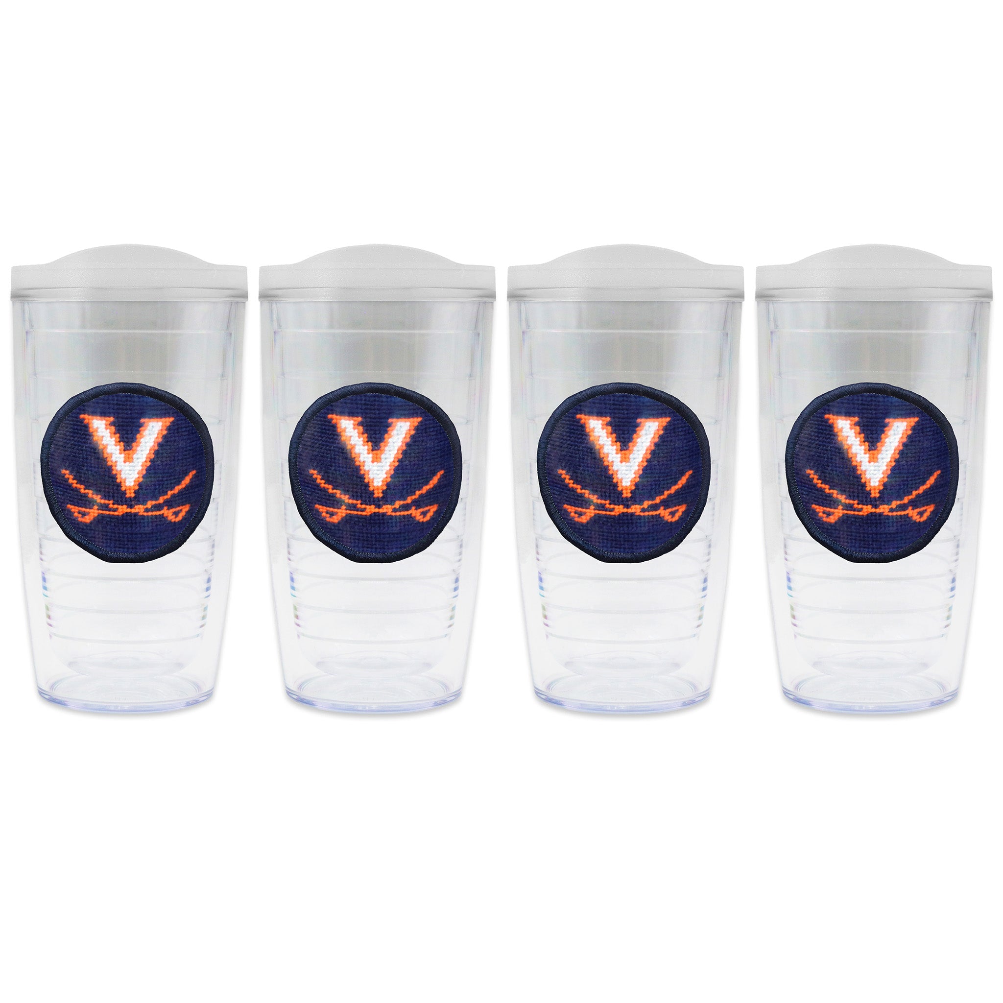 Set of 4 tumblers with lids on each in a line with a needlepoint logo in the center of each tumbler