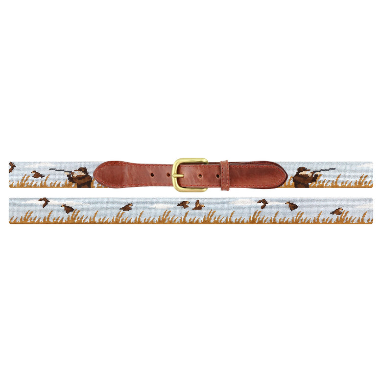 Flat view of Needlepoint Upland Shoot Belt with brown leather trim and a brass buckle