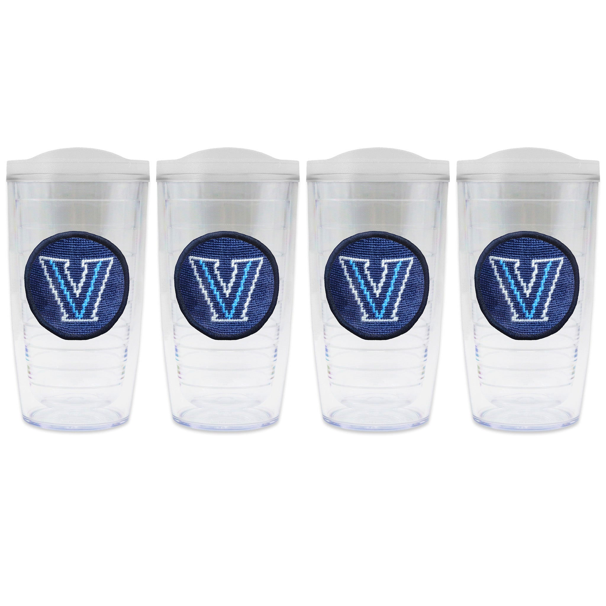 Set of 4 tumblers with lids on each in a line with a needlepoint logo in the center of each tumbler