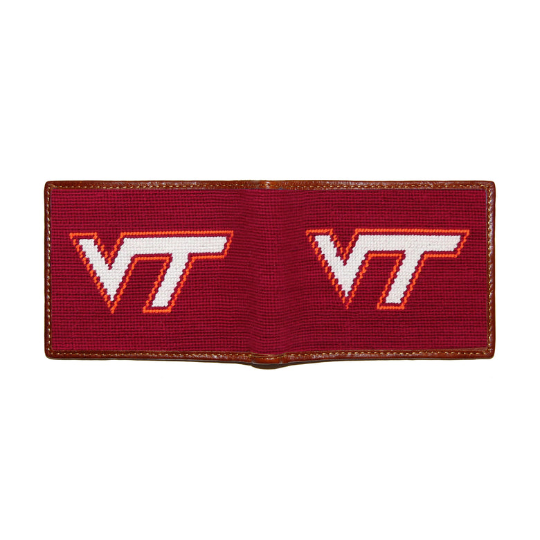 Virginia Tech maroon needlepoint bi-fold wallet open to show both sides of the orange “VT” logo needlepoint design with brown leather trim.