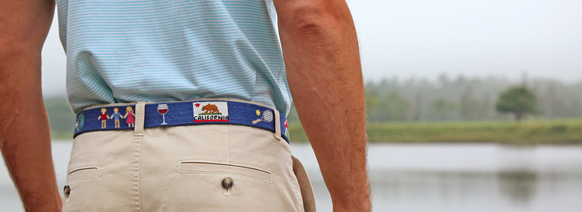 Model wearing a custom needlepoint belt. Save $50 with code LB50.