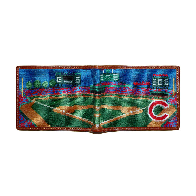 Wrigley Field navy needlepoint bi-fold wallet open to show both sides of the red Wrigley Field logo needlepoint design with brown leather trim.