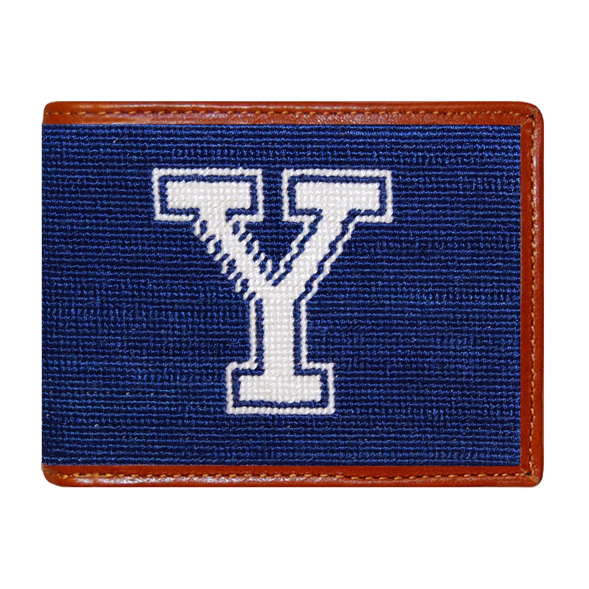 Yale needlepoint bi-fold wallet in navy and white with chestnut leather trim, shown from primary angle.